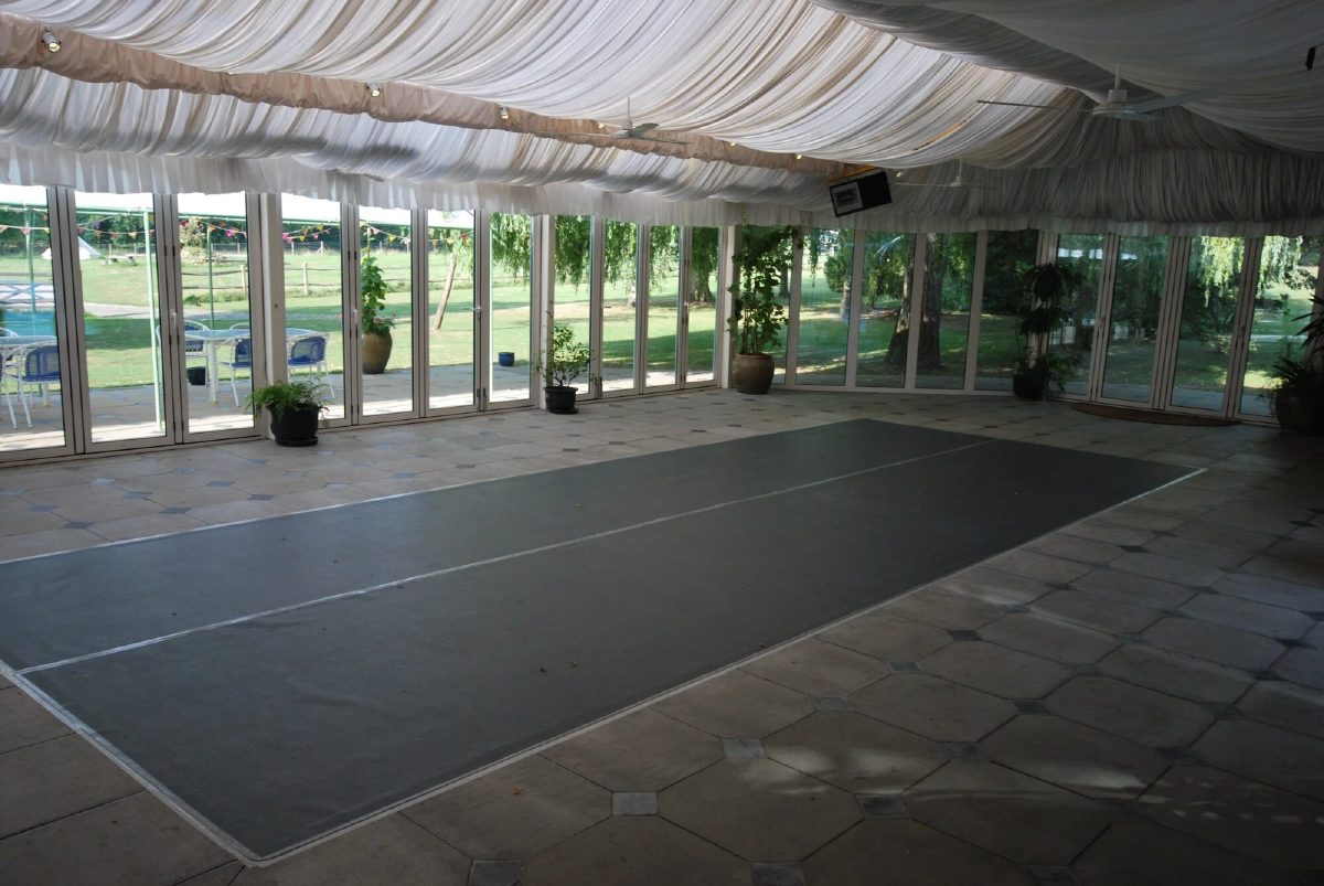 The pool house dressed for a party, with the floor over the swimming pool